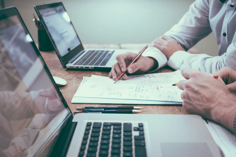 Business intelligence analyst reviewing multi-touch attribution models and marketing channel conversion paths